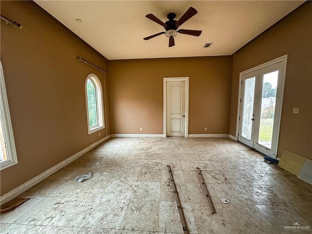 unfurnished room with ceiling fan and french doors