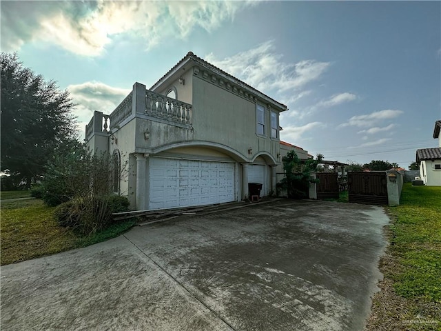 view of home's exterior with a garage and a balcony