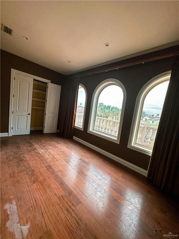 unfurnished bedroom with hardwood / wood-style floors