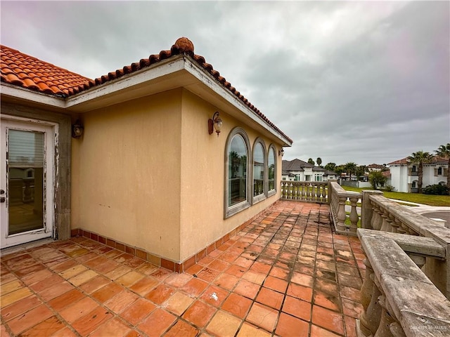 view of side of home with a patio area