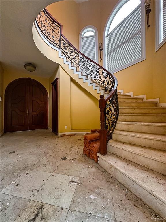 stairway featuring a high ceiling