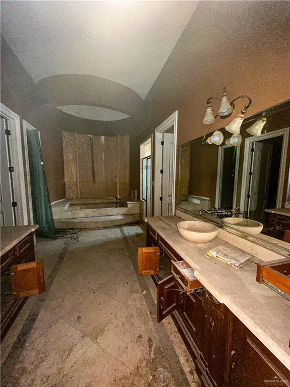 bathroom with vanity and vaulted ceiling