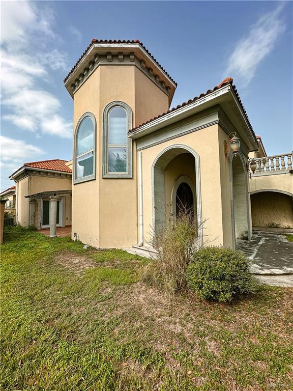 rear view of property with a lawn