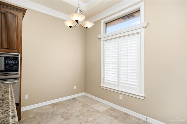 unfurnished dining area featuring a notable chandelier and ornamental molding