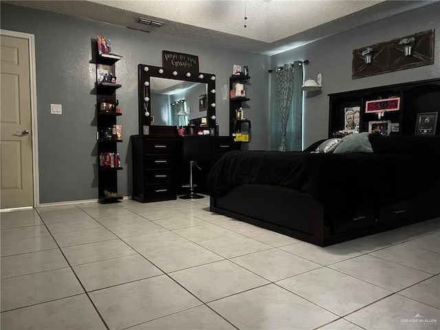 bedroom with light tile patterned floors and a textured ceiling