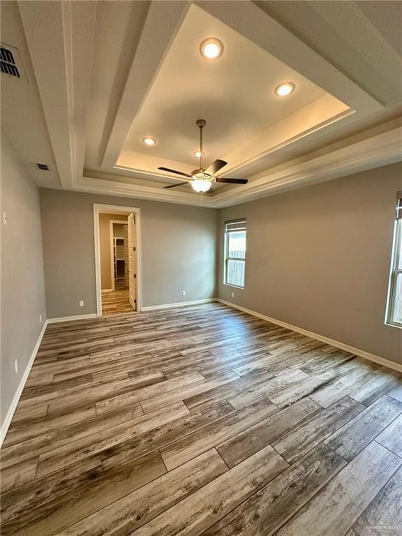 5016 Kendlewood Ave, Mcallen, TX 78501 - spare room featuring a raised ceiling, wood finished floors, ceiling fan, recessed lighting, and baseboards