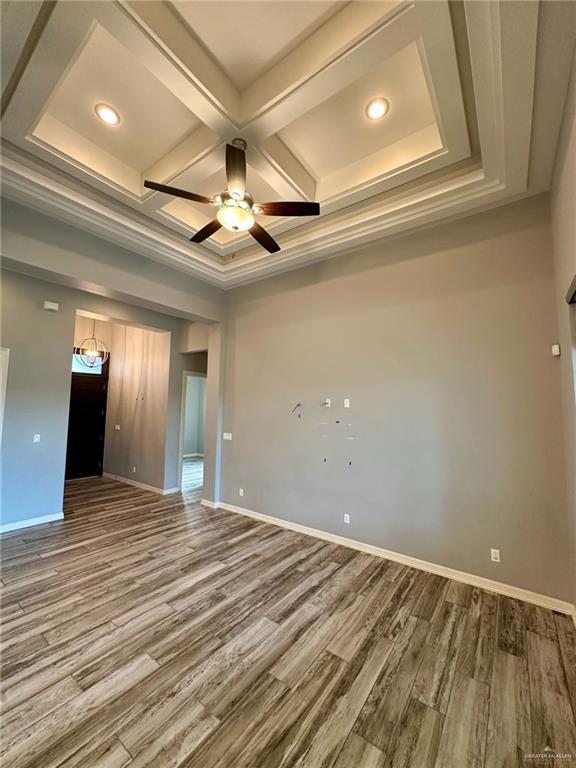 5016 Kendlewood Ave, Mcallen, TX 78501 - unfurnished room with coffered ceiling, wood finished floors, a ceiling fan, baseboards, and recessed lighting