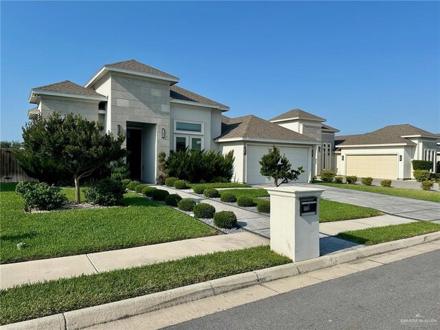 5016 Kendlewood Ave, Mcallen, TX 78501 - prairie-style house featuring a garage, concrete driveway, a front lawn, stucco siding, and a shingled roof