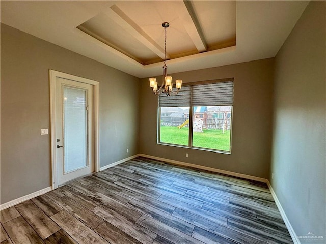 5016 Kendlewood Ave, Mcallen, TX 78501 - spare room featuring a raised ceiling, a chandelier, wood finished floors, and baseboards