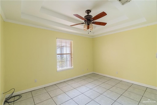 empty room with baseboards, a tray ceiling, and ceiling fan