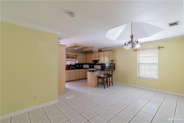 kitchen with dark countertops, visible vents, light tile patterned floors, crown molding, and a kitchen bar