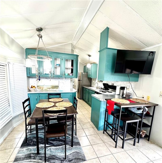 379 Sand Dollar Dr, Port Isabel, TX 78578 - kitchen with light countertops, backsplash, and freestanding refrigerator