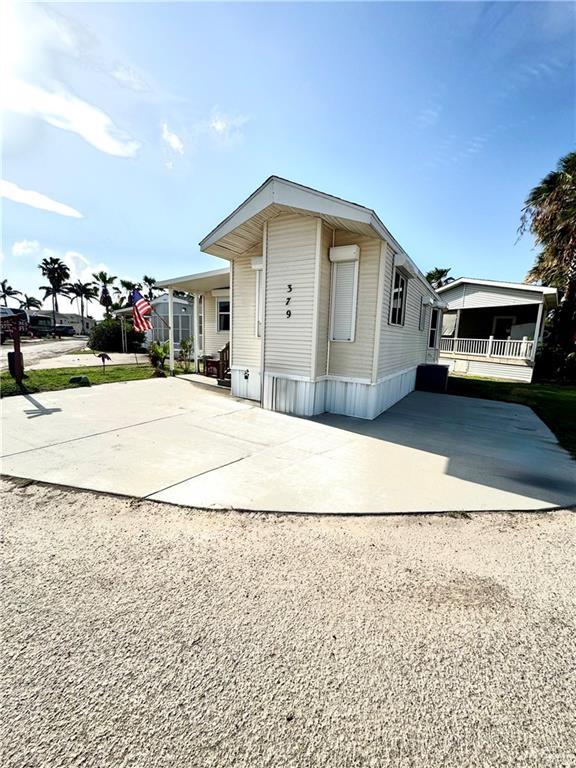 379 Sand Dollar Dr, Port Isabel, TX 78578 - manufactured / mobile home featuring concrete driveway and covered porch
