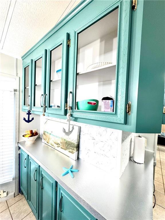 379 Sand Dollar Dr, Port Isabel, TX 78578 - bathroom with tile patterned flooring, a textured ceiling, and vanity
