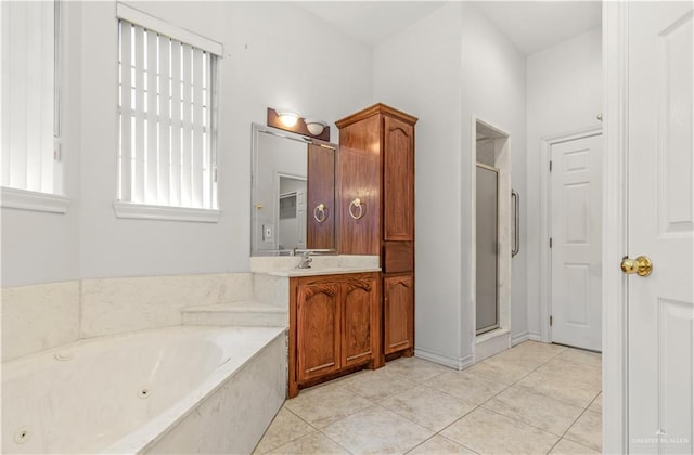 bathroom featuring tile patterned floors, vanity, and shower with separate bathtub