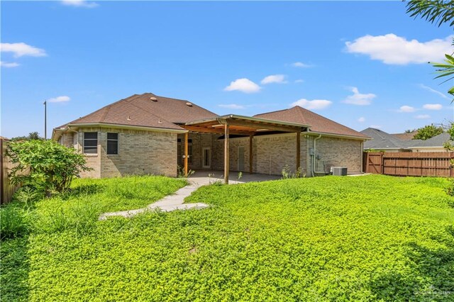 rear view of property with a patio and central AC unit