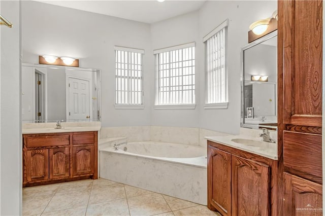 bathroom featuring a bath, vanity, tile patterned floors, and a wealth of natural light