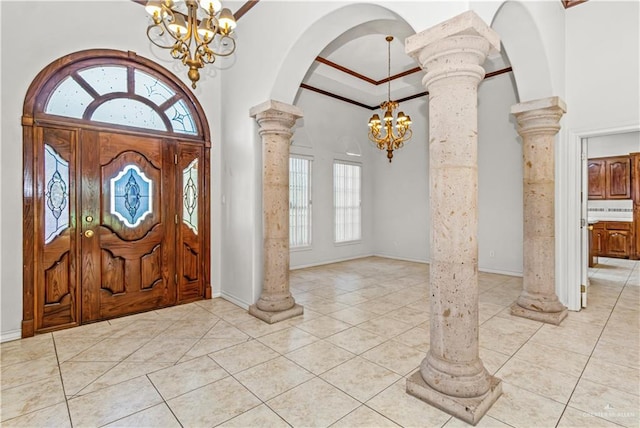 foyer with a healthy amount of sunlight, light tile patterned flooring, and an inviting chandelier