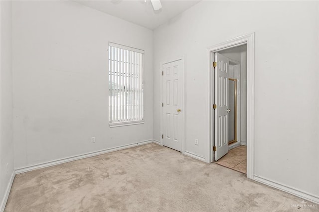 unfurnished bedroom with ceiling fan and light carpet