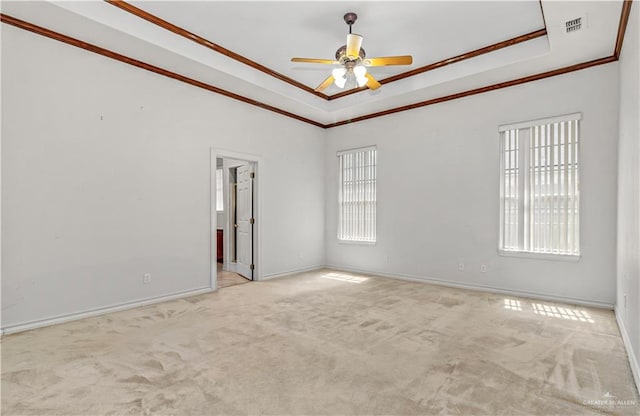 carpeted empty room featuring ceiling fan, a healthy amount of sunlight, and ornamental molding