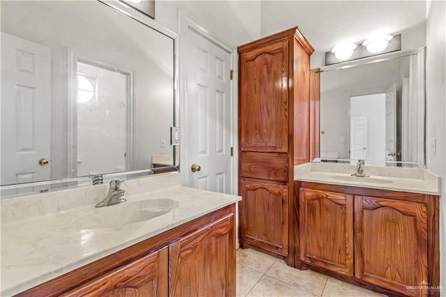 bathroom with tile patterned floors and vanity