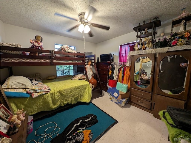 720 27 1/2 St, Mcallen, TX 78501 - bedroom featuring tile patterned floors, a textured ceiling, and a ceiling fan