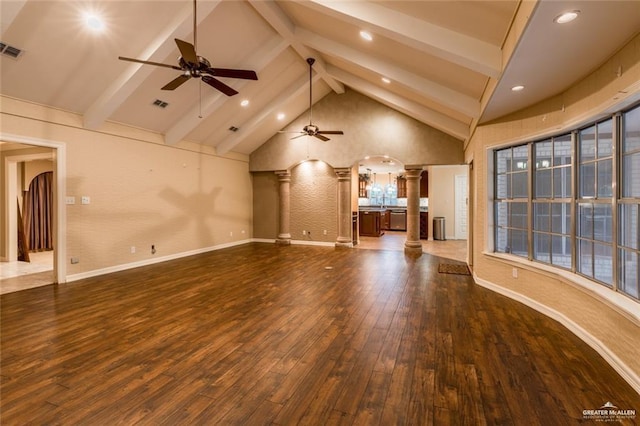 unfurnished living room featuring high vaulted ceiling, dark hardwood / wood-style flooring, beamed ceiling, ceiling fan, and decorative columns