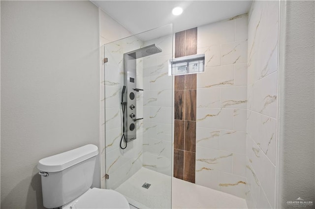 bathroom with walk in shower and toilet
