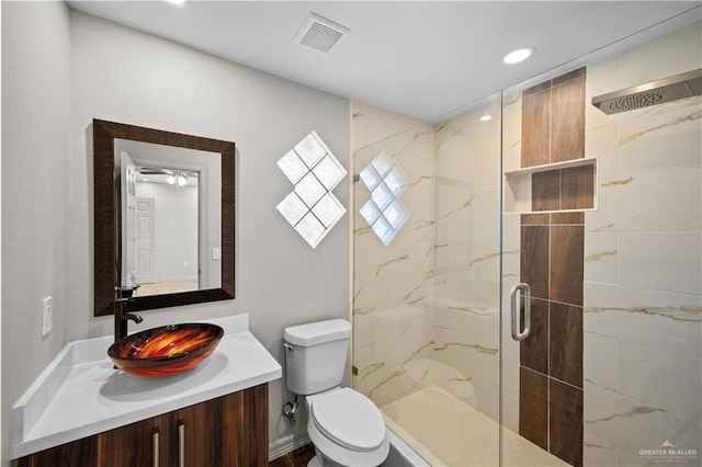 bathroom featuring visible vents, vanity, toilet, recessed lighting, and a marble finish shower