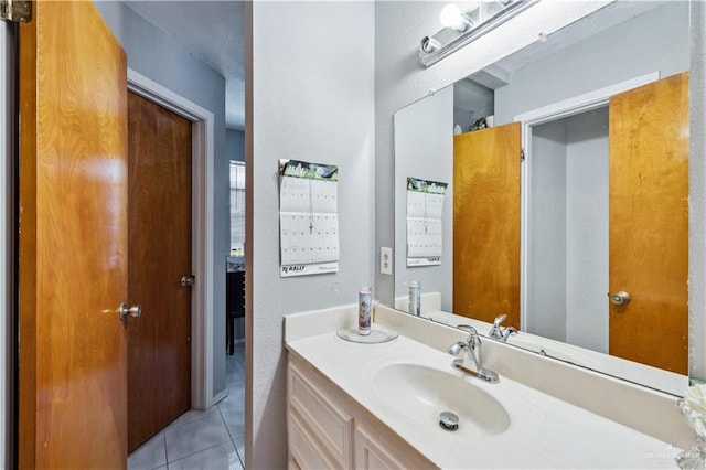 bathroom with tile patterned flooring and vanity