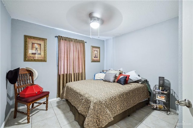 bedroom featuring light tile patterned flooring, baseboards, and ceiling fan