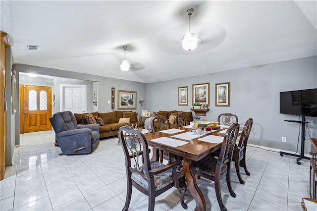 dining area featuring light tile patterned floors, vaulted ceiling, and ceiling fan