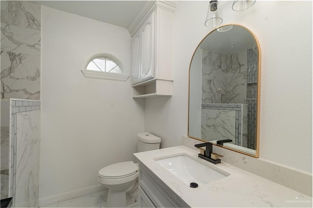 bathroom featuring vanity, toilet, and a tile shower