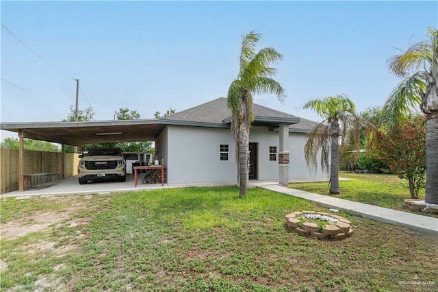 view of front of house with a front yard and a carport