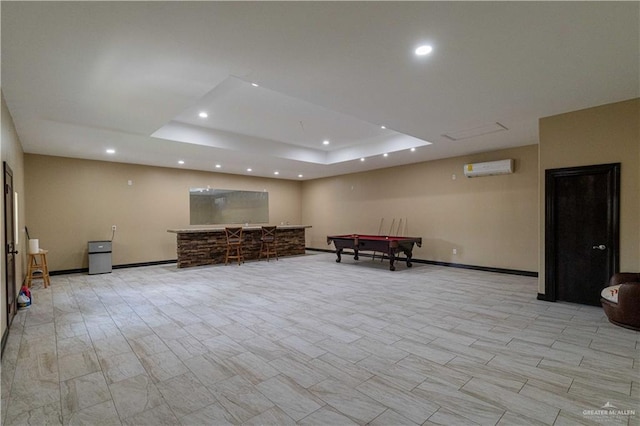 recreation room featuring a wall unit AC, a raised ceiling, and billiards