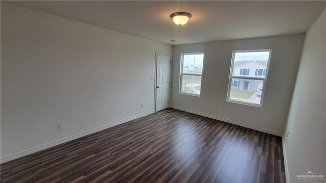 empty room with dark wood-type flooring