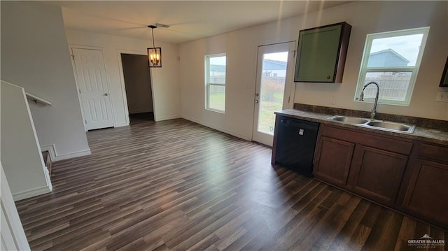 kitchen featuring sink, dark wood-type flooring, black dishwasher, and hanging light fixtures