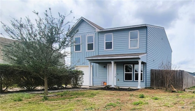 view of front facade with a front yard and a garage