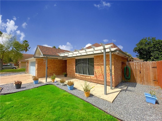 back of house with a lawn and a garage