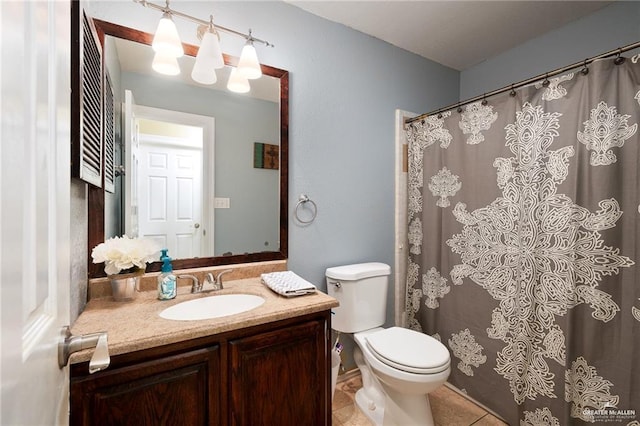 bathroom with tile patterned floors, vanity, and toilet