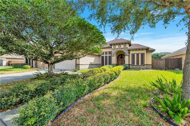 view of front facade featuring a garage and a front lawn