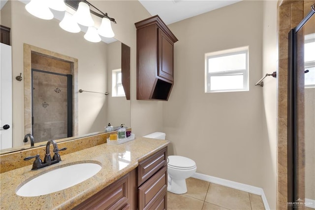 bathroom featuring vanity, a wealth of natural light, tile patterned floors, and a shower with shower door