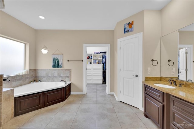 bathroom with vanity, tile patterned floors, and a bathing tub