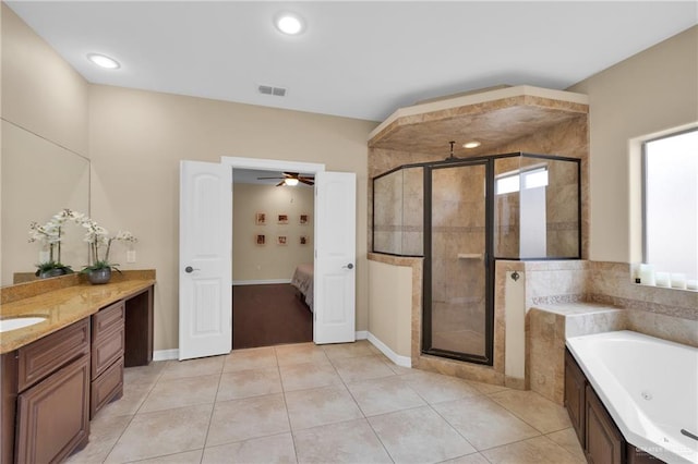 bathroom featuring independent shower and bath, vanity, and tile patterned floors