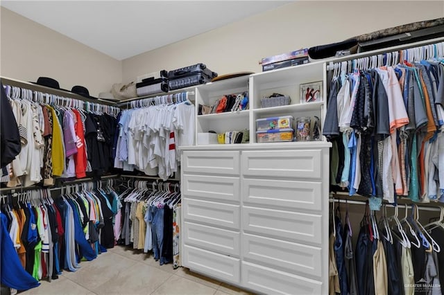 spacious closet featuring light tile patterned flooring