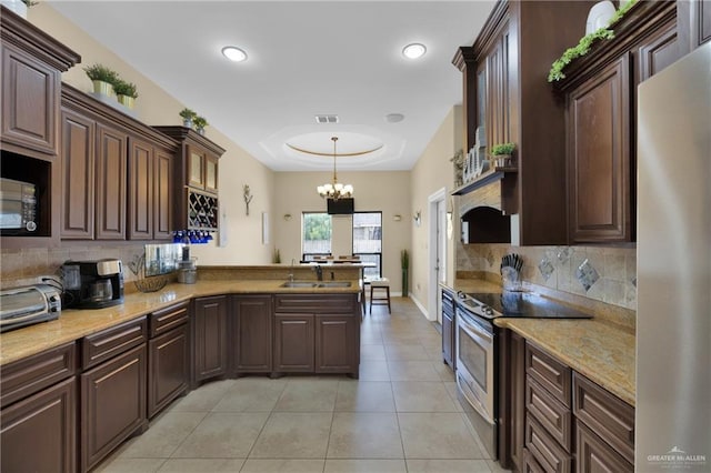 kitchen featuring hanging light fixtures, fridge, dark brown cabinetry, a tray ceiling, and stainless steel electric range