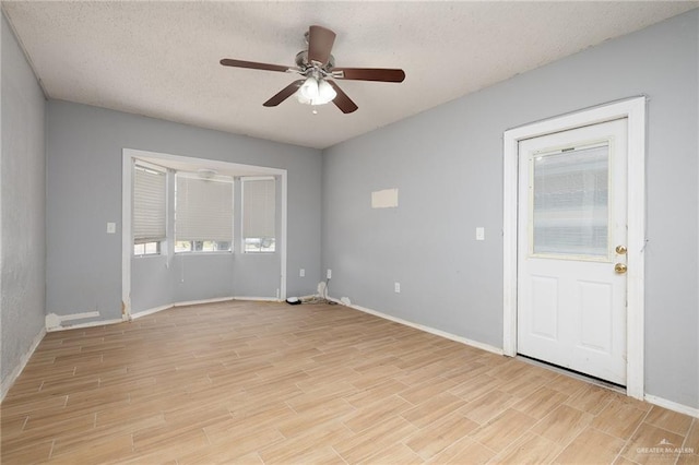 604 N Padre Ave, Weslaco, TX 78596 - unfurnished room with ceiling fan, light wood finished floors, and a textured ceiling