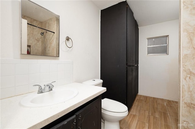 604 N Padre Ave, Weslaco, TX 78596 - bathroom featuring vanity, tasteful backsplash, wood finished floors, and a shower