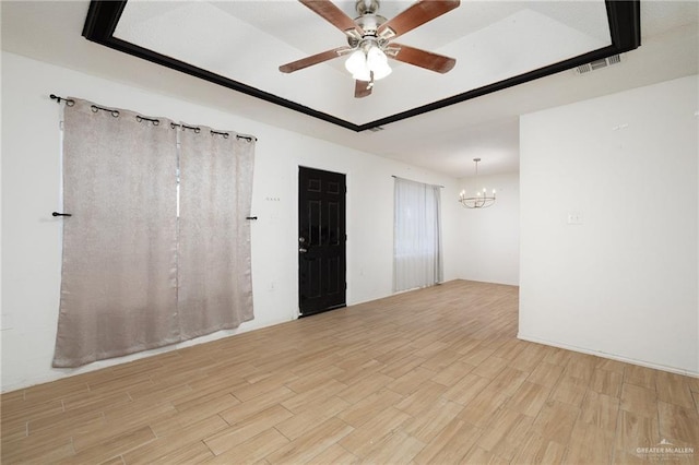 604 N Padre Ave, Weslaco, TX 78596 - unfurnished room featuring light wood finished floors, a chandelier, and a ceiling fan