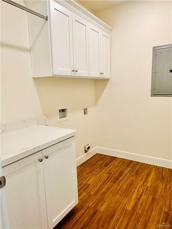 2110 Trinity, Donna, TX 78537 - laundry area with electric panel, cabinet space, washer hookup, dark wood finished floors, and hookup for an electric dryer